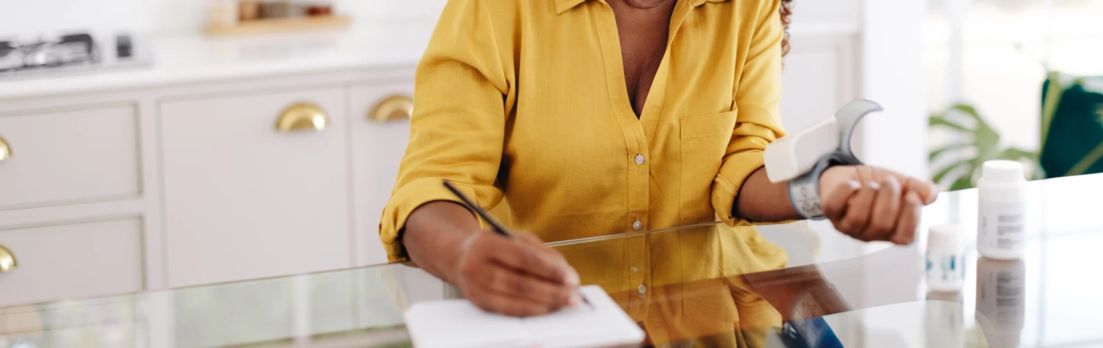 Chronic disease management: African American woman monitoring blood pressure at home