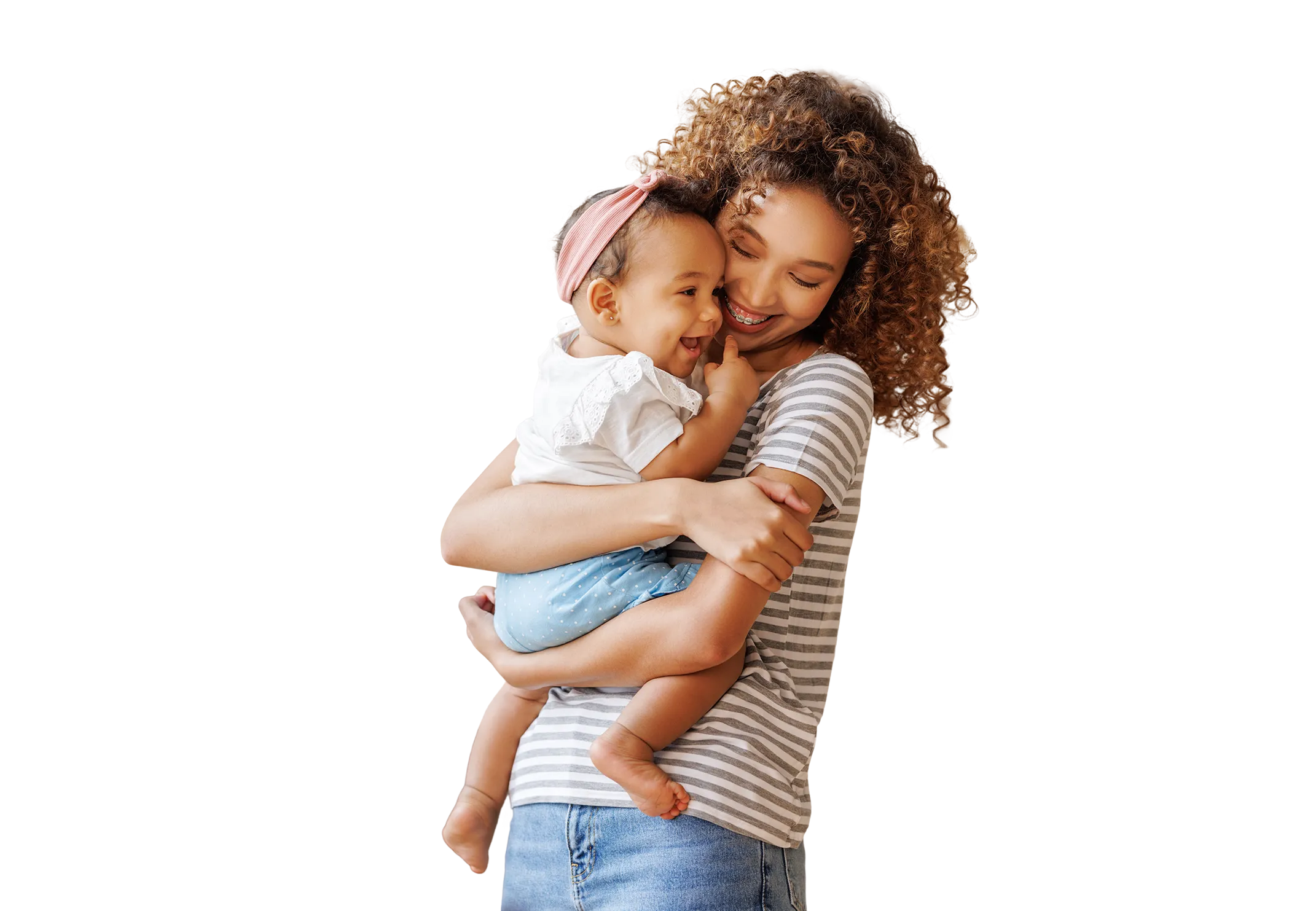 Mother smiling while holding a young child in her arms