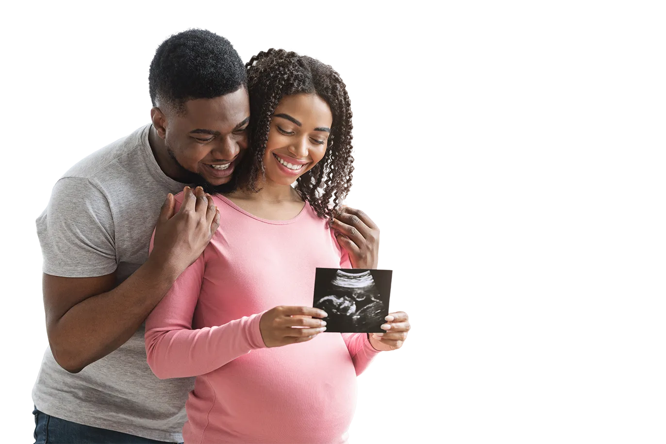 Pregnant woman and her partner smiling at an ultrasound photo