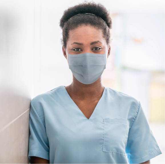 African American doctor wearing scrubs looking at camera