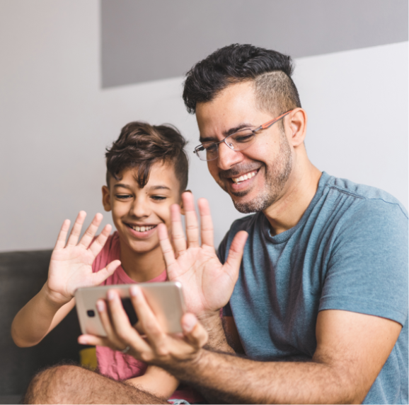 Dad and son communicating by video conference.