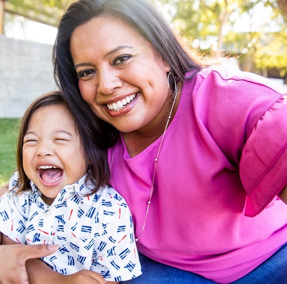 Hispanic mom and child smiling