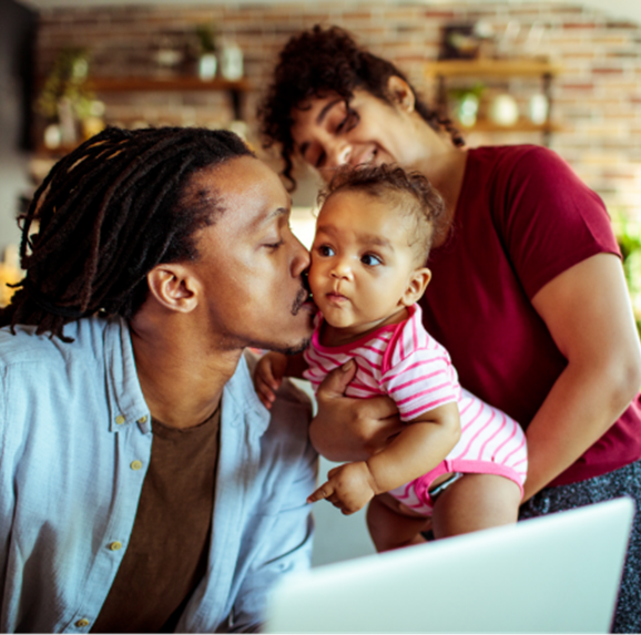 Young family in their living room using a laptop.