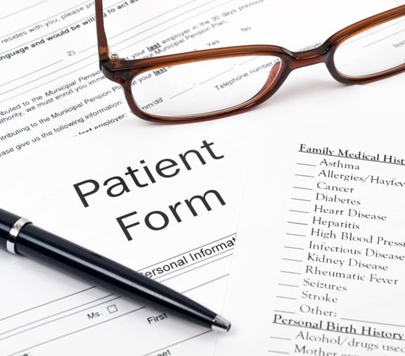 Patient form with pen and glasses