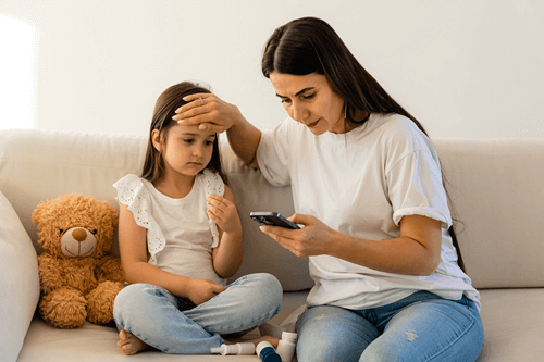 mother with daughter checking temperature